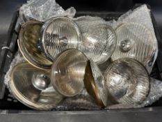 A tray of eight new old stock replacement glass lenses.