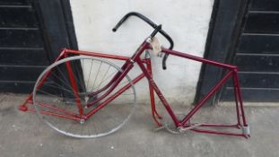 Two lightweight bicycle frames, both in red enamel.