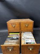 Two wooden banks of drawers containing photographs of cars etc.