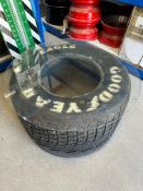 A Good Year Eagle F1 tyre with glass top forming a coffee table.