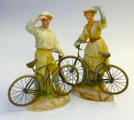 A pair of Gebruder Heubach. 'Bisque' figurines of a boy and girl bicycle riders with carefully