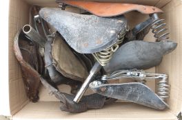 A box of various saddles.