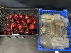 Two trays of lenses, approx. 50 red, 50 white.