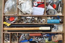 A bicycle components parts box with a hinged lid, with assorted parts.