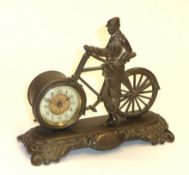 A mechanical clock held in the front wheel of a gentleman's bicycle, cast brass construction. An
