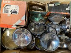 A box of approx. 15 lights - headlights and spotlights, some in original packaging.