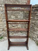 A Macfarlane Lang & Co. wooden shelving rack with carry handles to either side, in need of some
