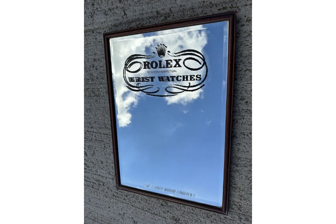 An advertising mirror from well known Mayfair wrist watch store, 20 1/2 x 28 3/4". - Image 1 of 2