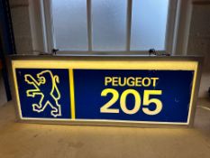 A Peugeot double sided hanging lightbox advertising the Peugeot 205 to one side and Peugeot 504