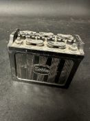 An Exide Batteries novelty ashtray with hinged lid and matchstriker to base, damage to one side
