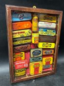 A collection of repair outfit tins within a glazed wall hanging cabinet including Dunlop, Britfix,