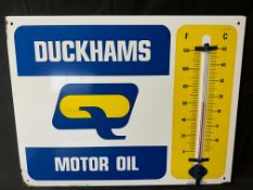 A Duckhams Motor Oil garage enamel advertising thermometer sign by Burnham, 26 1/2 x 20