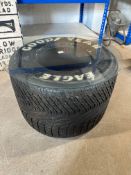 A Good Year Eagle F1 tyre with glass top forming a coffee table.