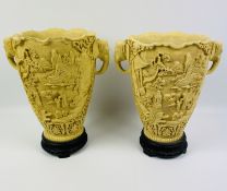 A pair of resin Oriental ivory style vases