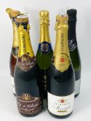 Two bottles of champagne together with three bottles of sparkling wine