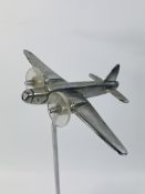 A vintage model of an aeroplane with a chrome finish and lucite propellers