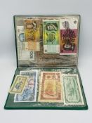 A folder containing a quantity of World bank notes