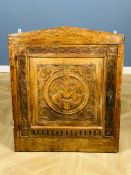 An antique carved corner cupboard