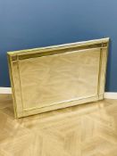 A contemporary silvered rectangular mirror with a bevelled main central mirror