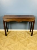 An early 20th century Chinese hardwood waisted corner leg table