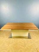 A contemporary melamine and wood effect dining room table