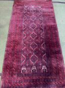An Iranian handmade red ground wool rug