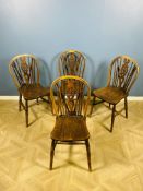 A set of four Victorian oak, elm and beechwood wheel back dining chairs