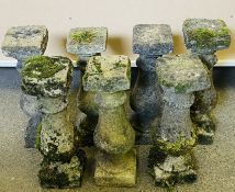 A collection of seven weathered concrete garden balustrades