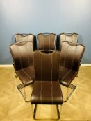 A set of six contemporary stitched leather and chrome effect dining chairs