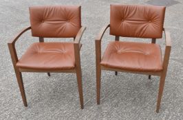 1 x Pair of Mid Century Style Armchairs Featuring Solid Wood Dark Stained Frames and Tan Leather