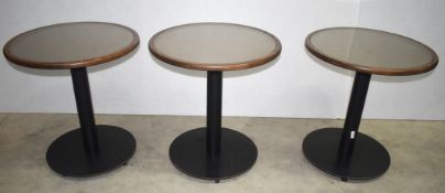 3 x Round Tables Featuring Smoked Glass Tops With Wooden Edging and Black Cast Iron Bases