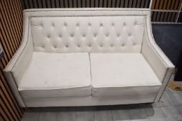 1 x Two Seater Fabric Sofa with White Ivory Fabric , Deep Buttoned Backrest and Metal Stud Detailing