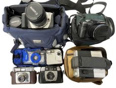 A mixed lot of various cameras in cases, some with accessories.