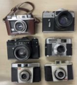Six vintage cameras to include: Zenit-E; Halina 35X; Voigtlnader Vito BL; Zenit TTL; Kodak