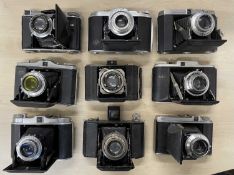 Nine vintage folding cameras to include Dacora I; Adox; Agfa Isolette; Kodak Duo 620; Voigtlander