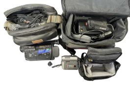 Three modern video cameras, in cases with some accessories.
