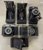 Six vintage folding cameras to include: Kodak No. 2 Folding Autographic Brownie; Goerz; GB