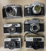 Six vintage cameras to include: EXA 1a; Zenit 3M; Konica CYCZeiss Ikon Contaflex; Ricoh 500G; Cosina