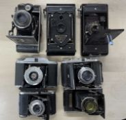 Seven vintage folding cameras to include: Rigona; Voigtlander Prontor II; GB kershaw 110; Baldar