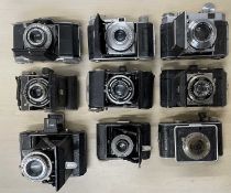 Nine vintage folding cameras, to include: Kodak Retina IIa; Zeiss Ikon (x2); Kodak Compur-Rapid (