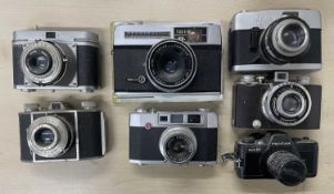 Seven vintage cameras to include Beirette VSN; Pentax Auto 110; Taron JL; Ideal Color 35; Perlux;