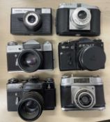 Six vintage cameras to include: Agfa Isola I; Cosmic Symbol; Zenit-E; Zenit 12XP; Zenit-E; Halina