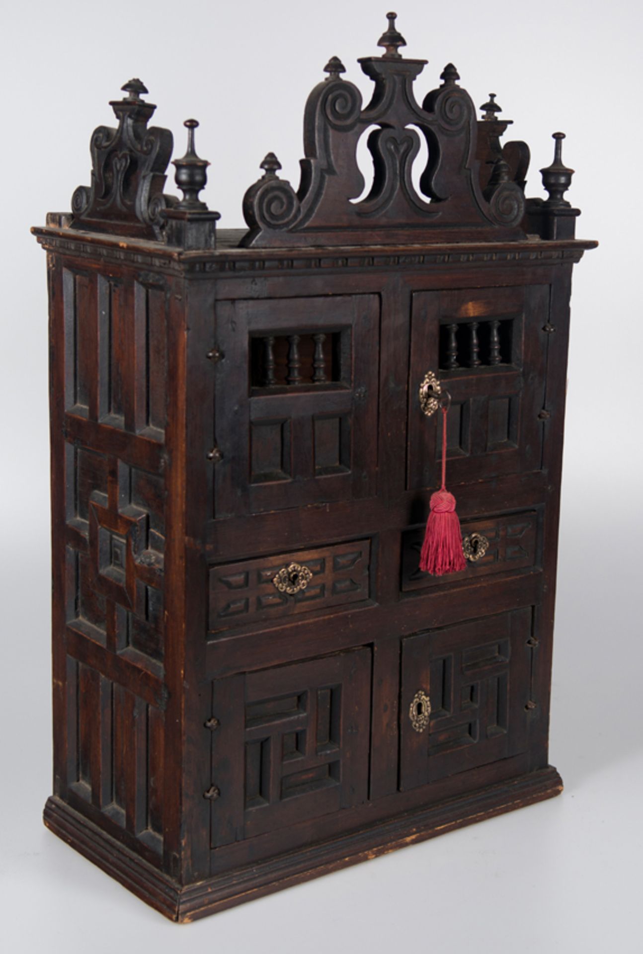 An spanish carved cedar and pine wooden cupboard with bronze fittings. 18th century.