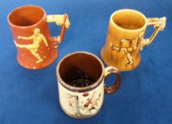 Football collectables, three 1950's tankards, a pair of Dartmouth Pottery Football tankards (