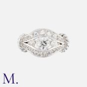 A Diamond Ring in platinum set with three round cut stones to the centre, the largest of which is