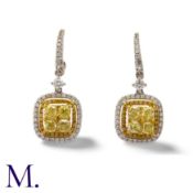 A Pair of Yellow and White Diamond Earrings in 18K yellow and white gold. Each earrings is set