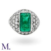An Emerald And Diamond Ring in 14k white gold, set with a principal sugarloaf cabochon emerald of