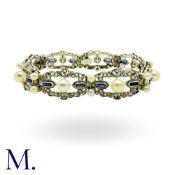 A Pearl And Sapphire Bracelet in 14k white gold, set with bullet cut sapphires and pearls, the