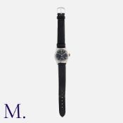 OMEGA, A Vintage Gents Military Style Wristwatch in stainless steel. The black dial with alternating