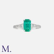 A Fine Colombian Emerald And Diamond Ring in 18k white gold, set with a principal octagonal cut